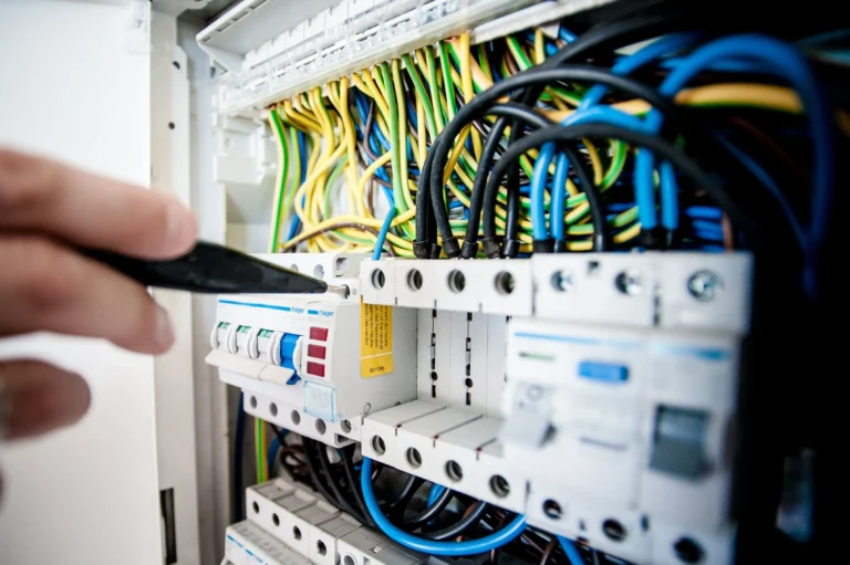 Electrician inspecting an electrical panel and circuit breakers