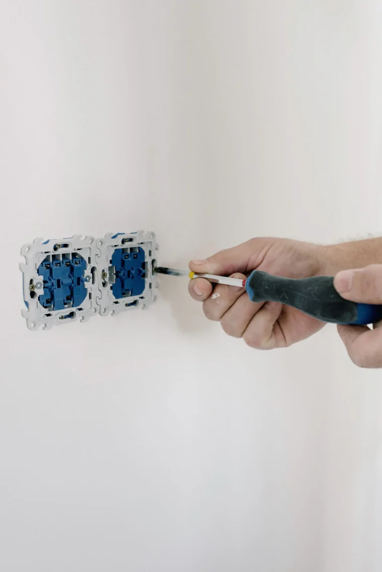 Electrician installing and securing a wall light switch