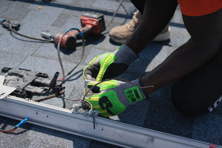 Electrician performing electrical work on a rooftop system